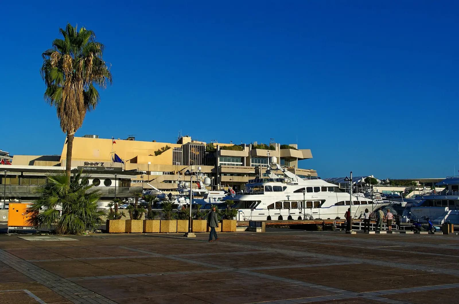 The Palais des Festivals et des Congrès seen from the Promenade de la Pantiero, with a yacht moored alongside