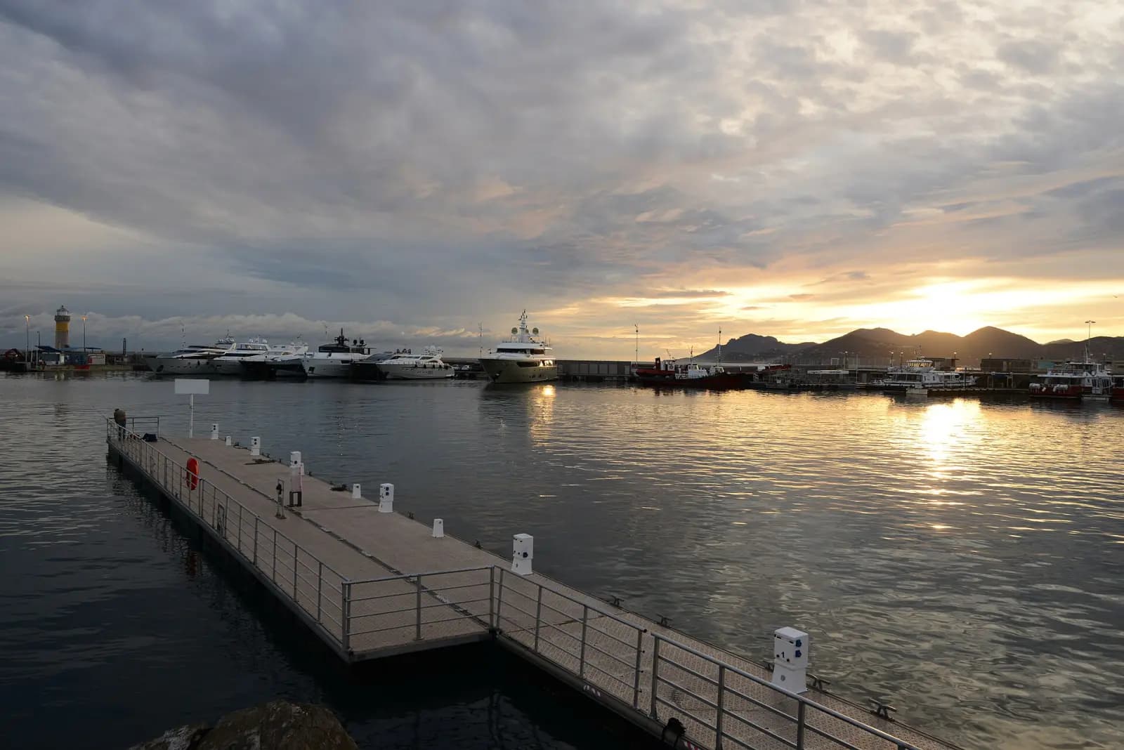 The Old Port of Cannes at sunset, with its pontoons and yachts